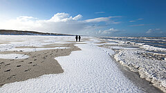 Weihnachten auf Juist - Schnee am Strand mit Menschen in der Ferne